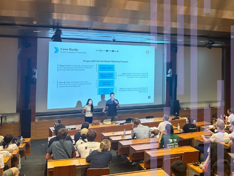 Thomas Zamin and a teammate present their hyperloop route-planning case study to a lecture hall at European Hyperloop Week 2024.